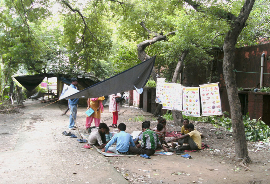An den Kontaktpunkten können die Kinder auch lesen und schreiben lernen. Eine Investition in ihre Zukunft, die enorm wichtig ist. Die Kinder wissen das und lernen begierig. Straßenkinder sitzen vor Lerntafel