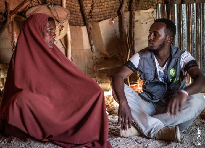 Von Hunger bedrohte Frau sitzt mit einem Mann in einem Zelt in Ostafrika