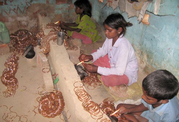 Zehn Stunden pro Tag an sieben Tagen in der Woche sitzen sie in Abgasen und verschmelzen die Enden von Glasreifen, damit Glasarmbänder entstehen, die in Indien sehr beliebt sind. Wer sie aus dieser Arbeit befreit, rettet ihre Zukunft. Schule, Sklaverei, Ausbildung, Indien, Asien, Kinder, Bildung, Rechte